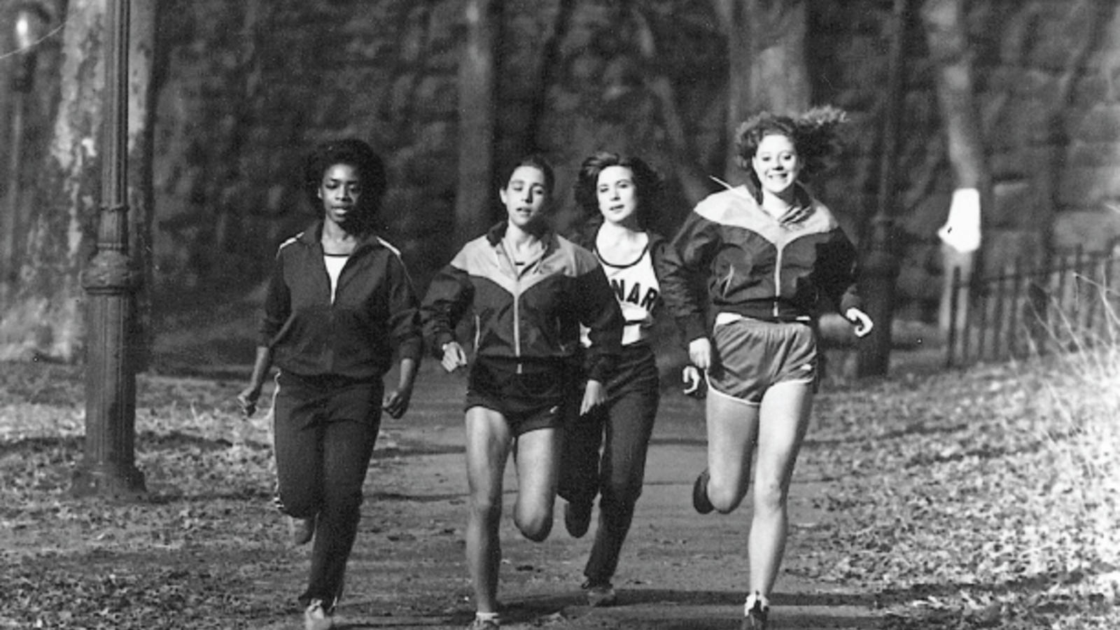 4 women runners circa 1982 running through a park, black and white image